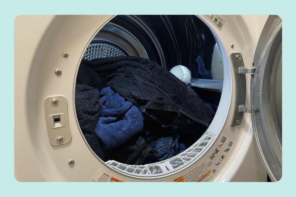 A load of towels is placed in the dryer for Yahoo's Best Bath Towel guide.