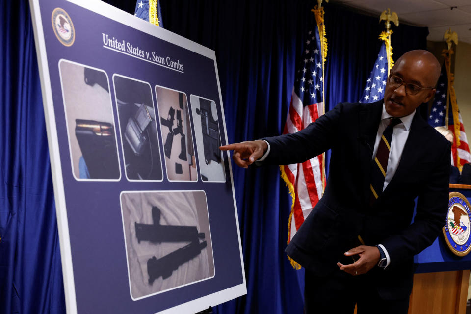 U.S. Attorney Damian Williams points at a chart, during a press conference to announce the unsealing of an indictment charging music mogul Sean 