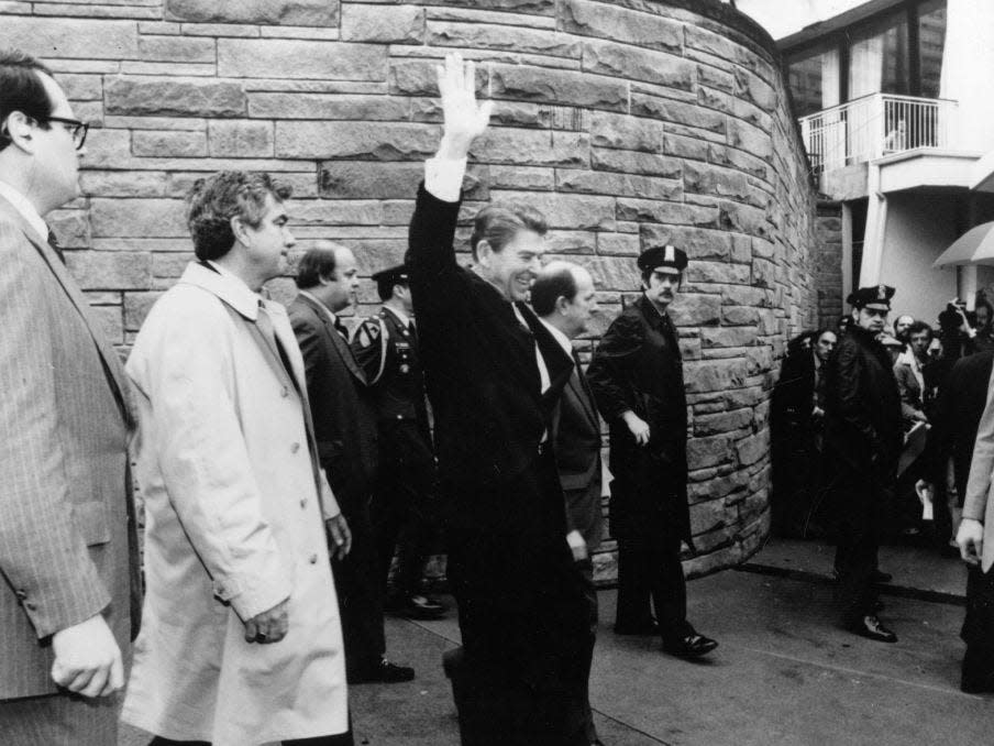 Ronald Reagan waves as he is photographed shortly before an assassination attempt.