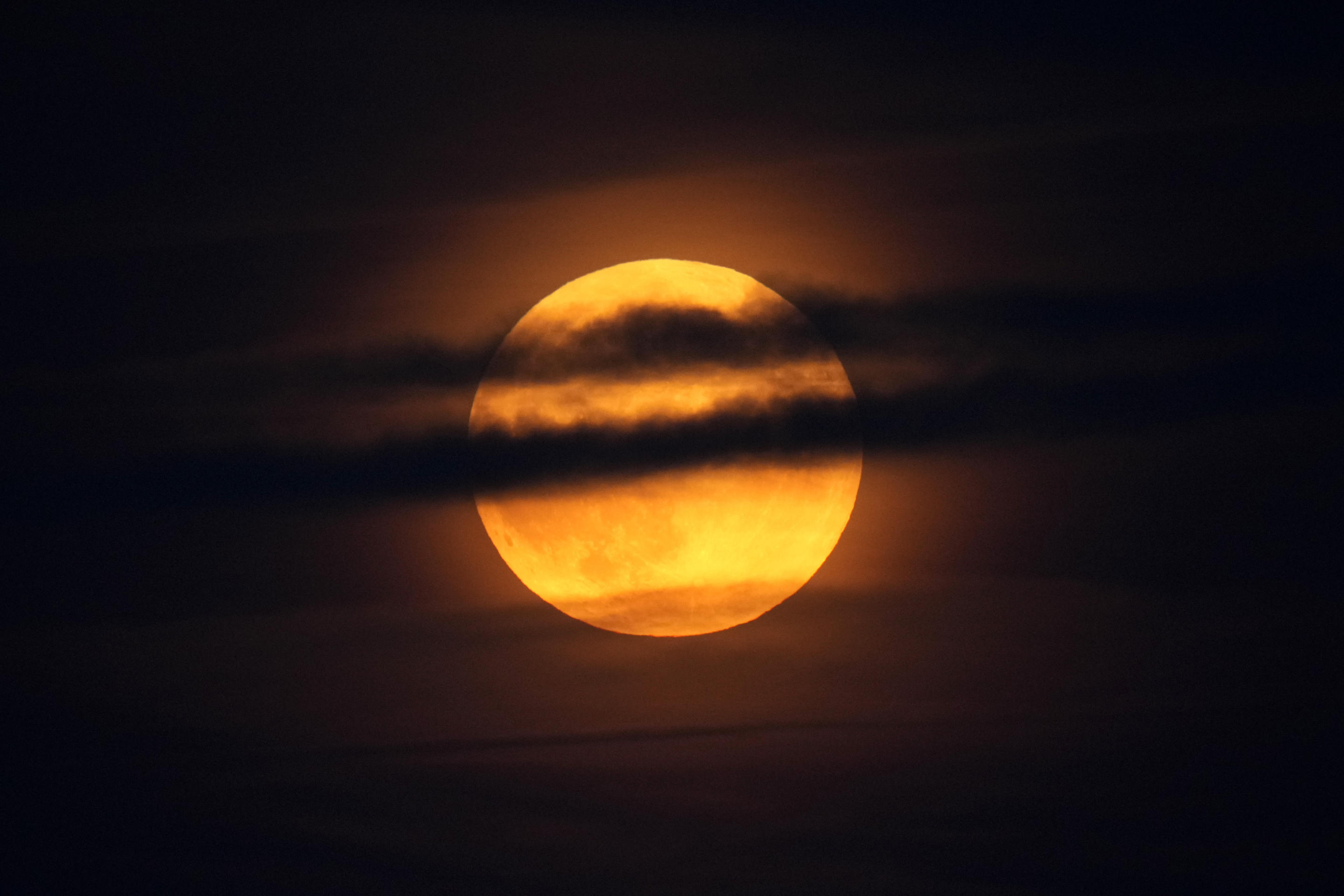 The moon rises through clouds over the Atlantic Ocean off the coast of Camden, Maine, Sept. 17. (Robert F. Bukaty/AP)