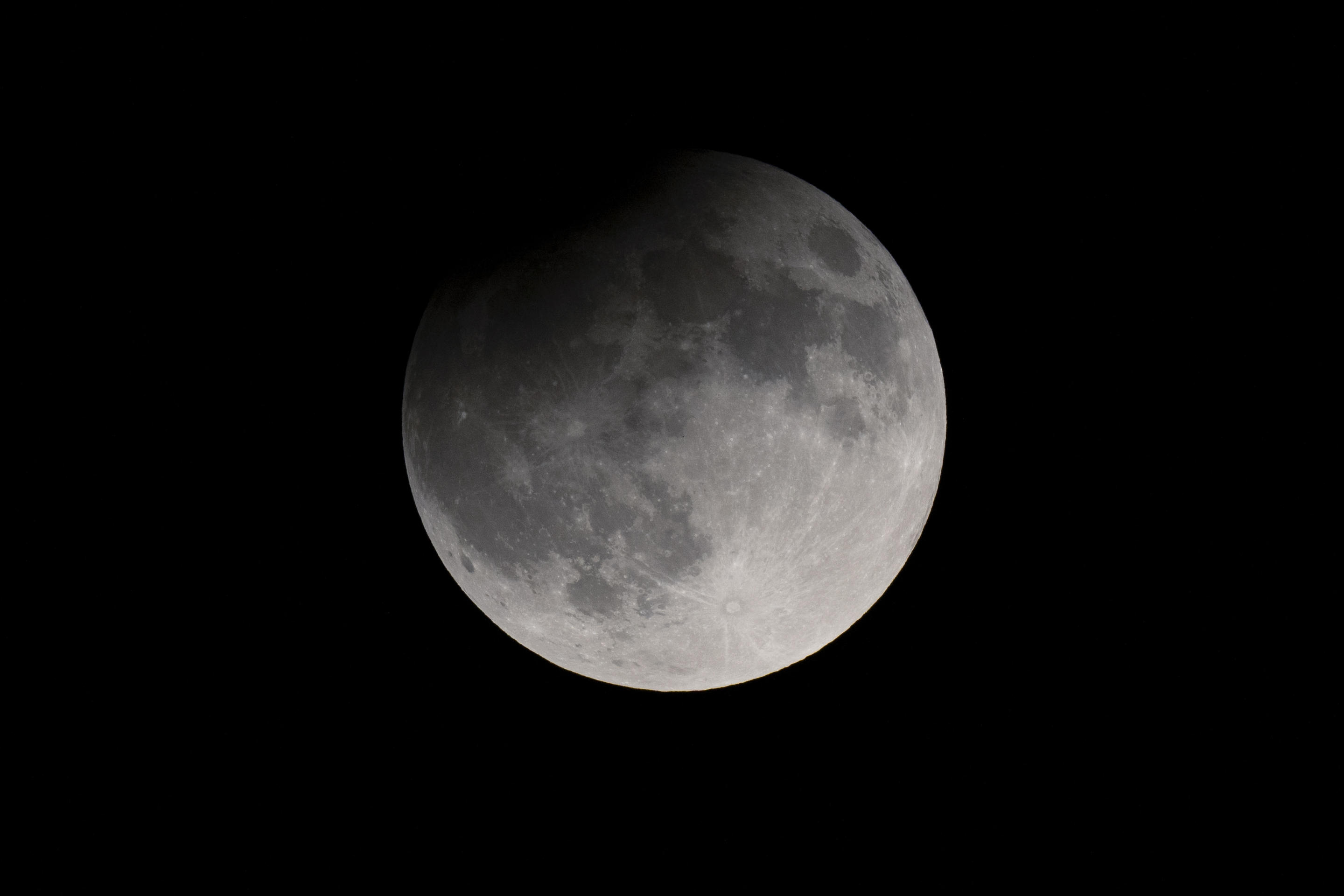 A partial eclipse darkens a rising supermoon in Nashville, Tenn., on Sept. 17. (George Walker IV/AP)