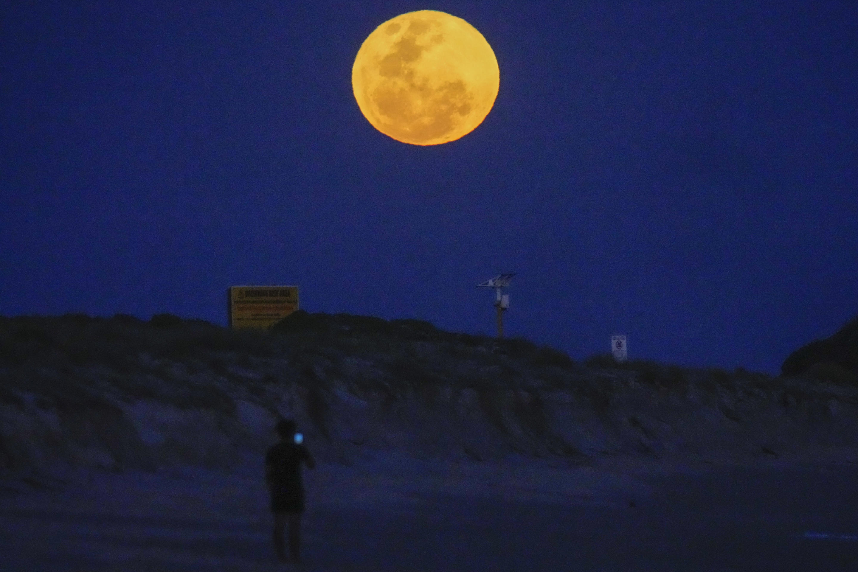 The moon rises over Fingal Bay in Port Stephens north of Sydney, Australia, Sept. 18. (Mark Baker/AP)