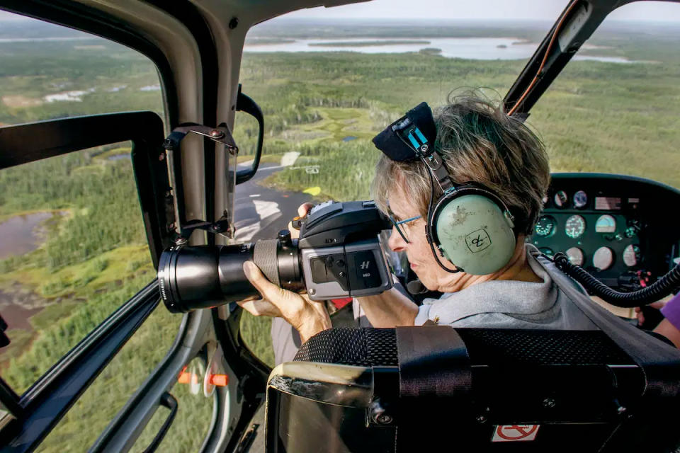 Former astronaut Roberta Bondar aboard a helicopter tracks the flight corridors used by migratory birds to gather imagery for 