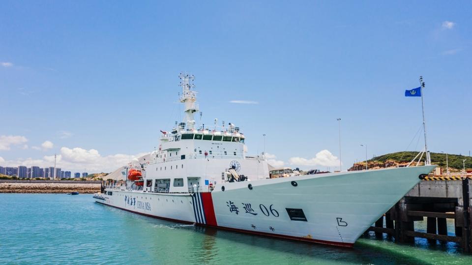 A Chinese Coast Guard patrol ship sitting in blue water against a blue sky.