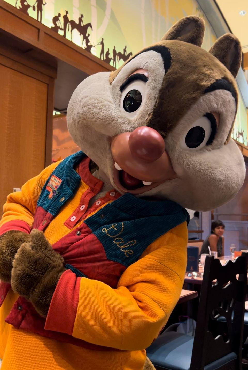 Dale greets guests with smiles and hugs during Mickey’s Autumn Adventures Breakfast Buffet at Storytellers Cafe.