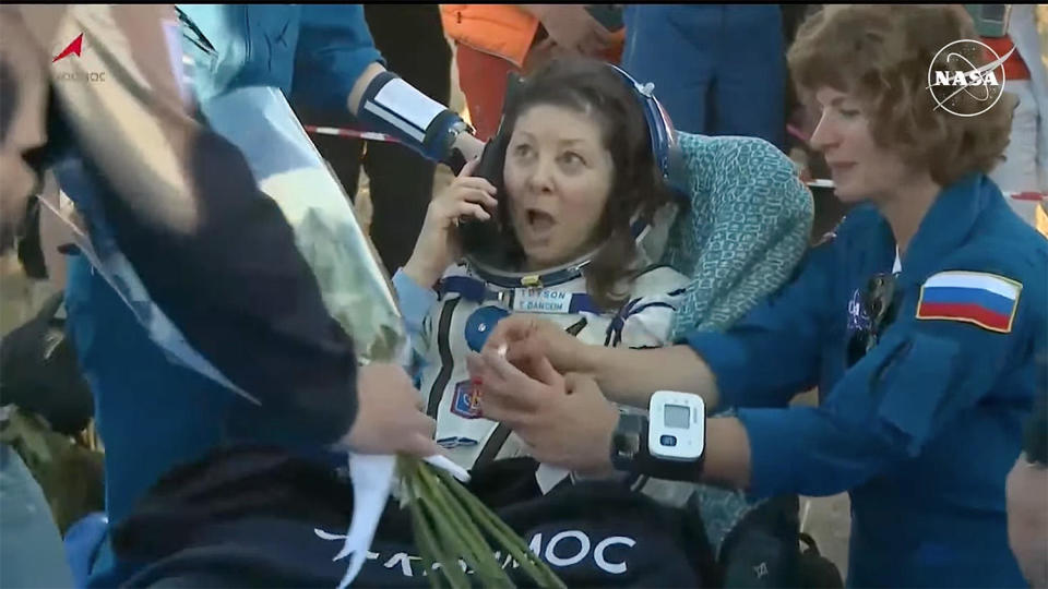 Oleg Novitskiy, commander of the Soyuz that carried NASA astronaut Tracy Dyson to orbit last March, welcomed his former crewmate back to Earth with a bouquet of flowers, much to her obvious surprise and delight. / Credit: NASA/Roscosmos