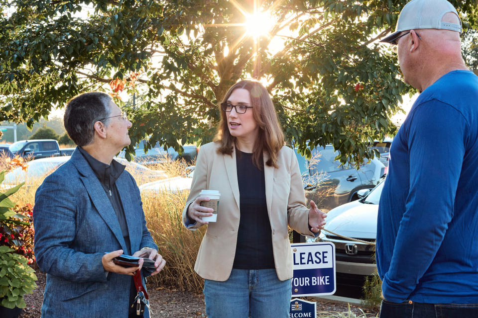 Sarah McBride, center, talks to Lisa Goodman, left, and Delaware state Sen. Russ Huxtable (Jana Williams for NBC News)