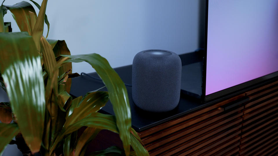 An Apple HomePod 2023 on a media stand.