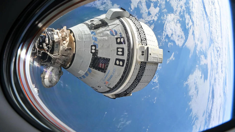  A cone-shaped spacecraft visible through a space station window. behind is earth. 