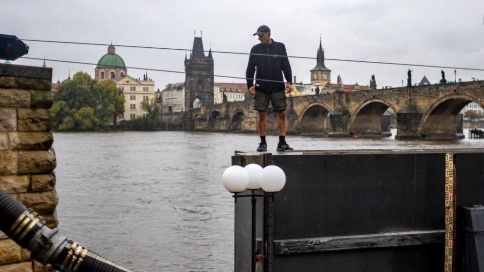 A worker prepares to close an anti-flood gate on Vltava river in the city center of Prague, Czech Republic, 13 September 2024