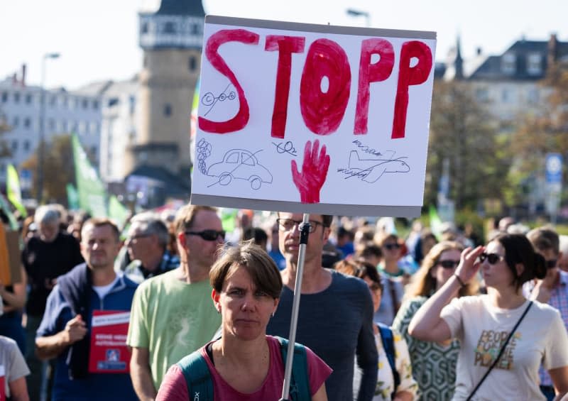 A woman holds a placard during a demonstration to mark Fridays for Future's global climate strike. Boris Roessler/dpa