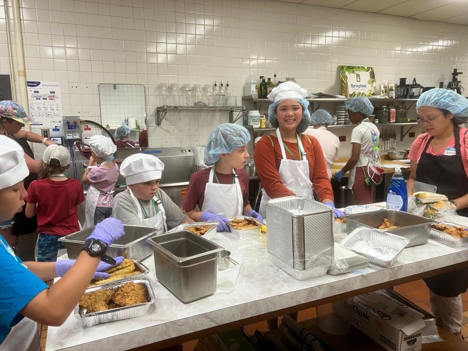 Springfield Community Garden's Grow to Ride 4-H club members portion food from the Cox North cafeteria line in this undated photo. A grant will allow SCG to work with Cox North and 4-H to divert food waste in order to reduce food insecurity in the community.