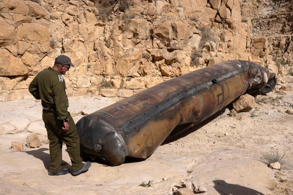 An Israeli soldier examines part of an Iranian ballistic missile fired at Israel during Iran's direct attack in April.