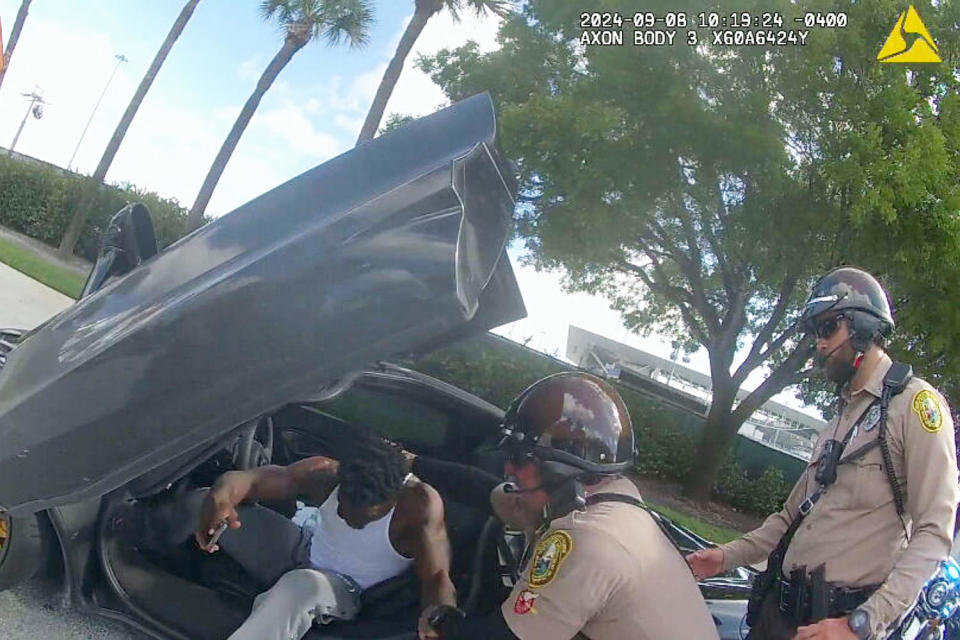 nfl football player arrest vehicle car extraction by force forcibly (Miami Dade Police Dept)