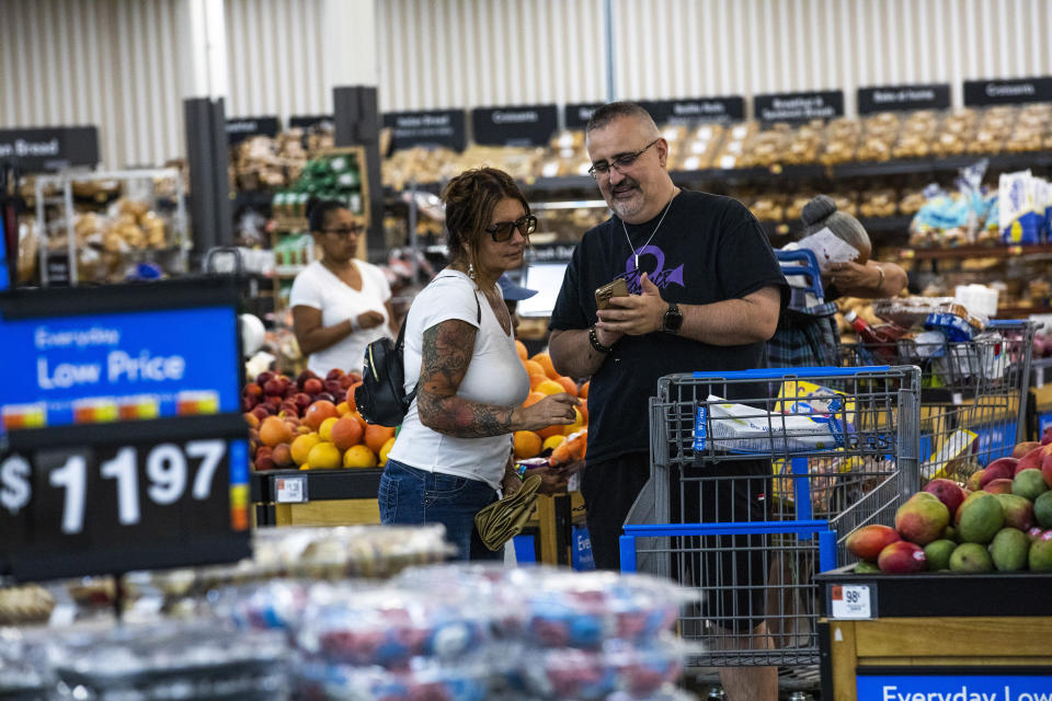 FILE - Shoppers pause in the produce section at a Walmart Superstore in Secaucus, New Jersey, July 11, 2024. (AP Photo/Eduardo Munoz Alvarez, File)