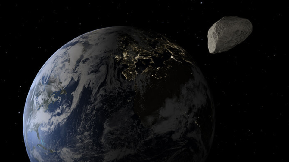 The Earth is seen with a space rock toward its top right.