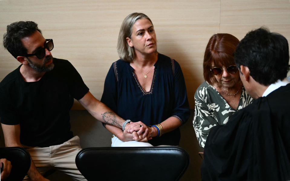 Gisele Pelicot (right) speaks to one of her lawyers, beside her daughter Caroline Darian (center) and her son, at the courthouse during the trial of her husband accused of drugging her for nearly ten years and inviting strangers to rape her at their home in Mazan, a small town in the south of France, in Avignon, on September 2, 2024.  / Credit: CHRISTOPHE SIMON/AFP via Getty Images