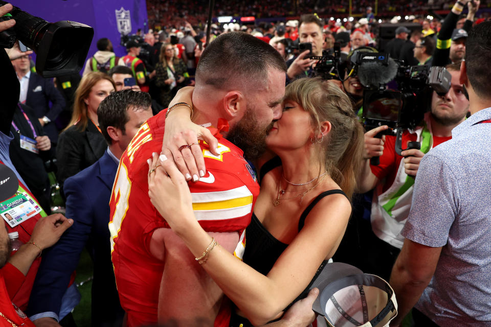 Travis Kelce and Taylor Swift in a passionate embrace 