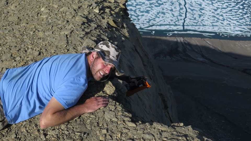 Study coauthor David Bond, a paleoenvironmental scientist at the University of Hull, looks for new sections of rock that reflect the end-Permian mass extinction on Ellesmere Island in the Canadian Arctic. - Paul Wignall