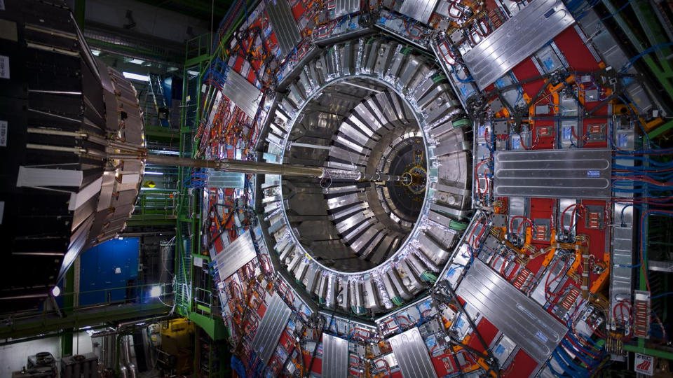  A giant circular computing machine hollow in the center where a thin copper tube passes through. It's like the retina of a giant robot eye. 