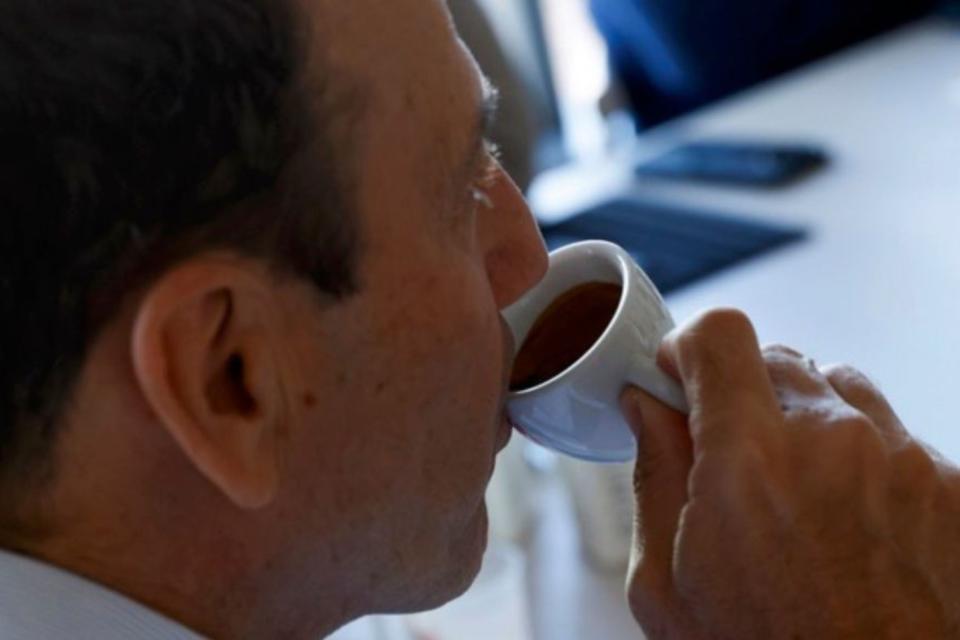 Man drinking cup of espresso.