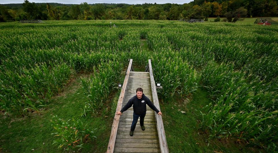 John "JD" Davis, Davis Mega Maze head of mazing and maintenance, stands on one of the bridges in the candy-themed maze.