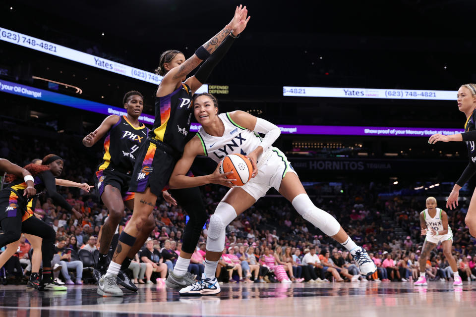 PHOENIX, ARIZONA - AUGUST 28: Kayla McBride #21 of the Minnesota Lynx drives into Natasha Cloud #0 of the Phoenix Mercury during the first half at Footprint Center on August 28, 2024 in Phoenix, Arizona.The Lynx defeated the Mercury 89-76.  NOTE TO USER: User expressly acknowledges and agrees that, by downloading and or using this photograph, User is consenting to the terms and conditions of the Getty Images License Agreement.  (Photo by Chris Coduto/Getty Images)