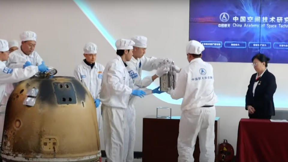  Technicians remove the samples collected on the moon's far side from the return capsule of the Chang'e 6 lunar mission. 