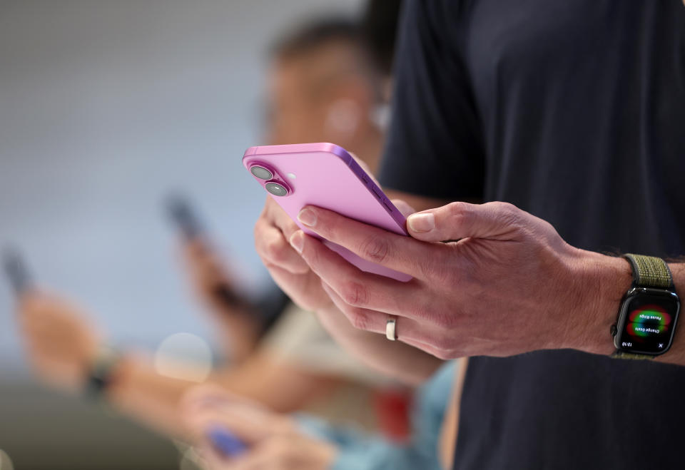 CUPERTINO, CALIFORNIA - SEPTEMBER 09: An attendee inspects the the new iPhone 16 Pro Max during an Apple special event at Apple headquarters on September 09, 2024 in Cupertino, California. Apple held an event to showcase the new iPhone 16, Airpods and Apple Watch models. (Photo by Justin Sullivan/Getty Images)