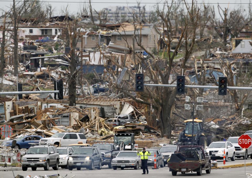 A police officer directs traffic on Friday, May 27, 2011, in Joplin, Mo. A tornado tore through much of Joplin Sunday, killing at least 132. (AP Photo/Mark Humphrey)