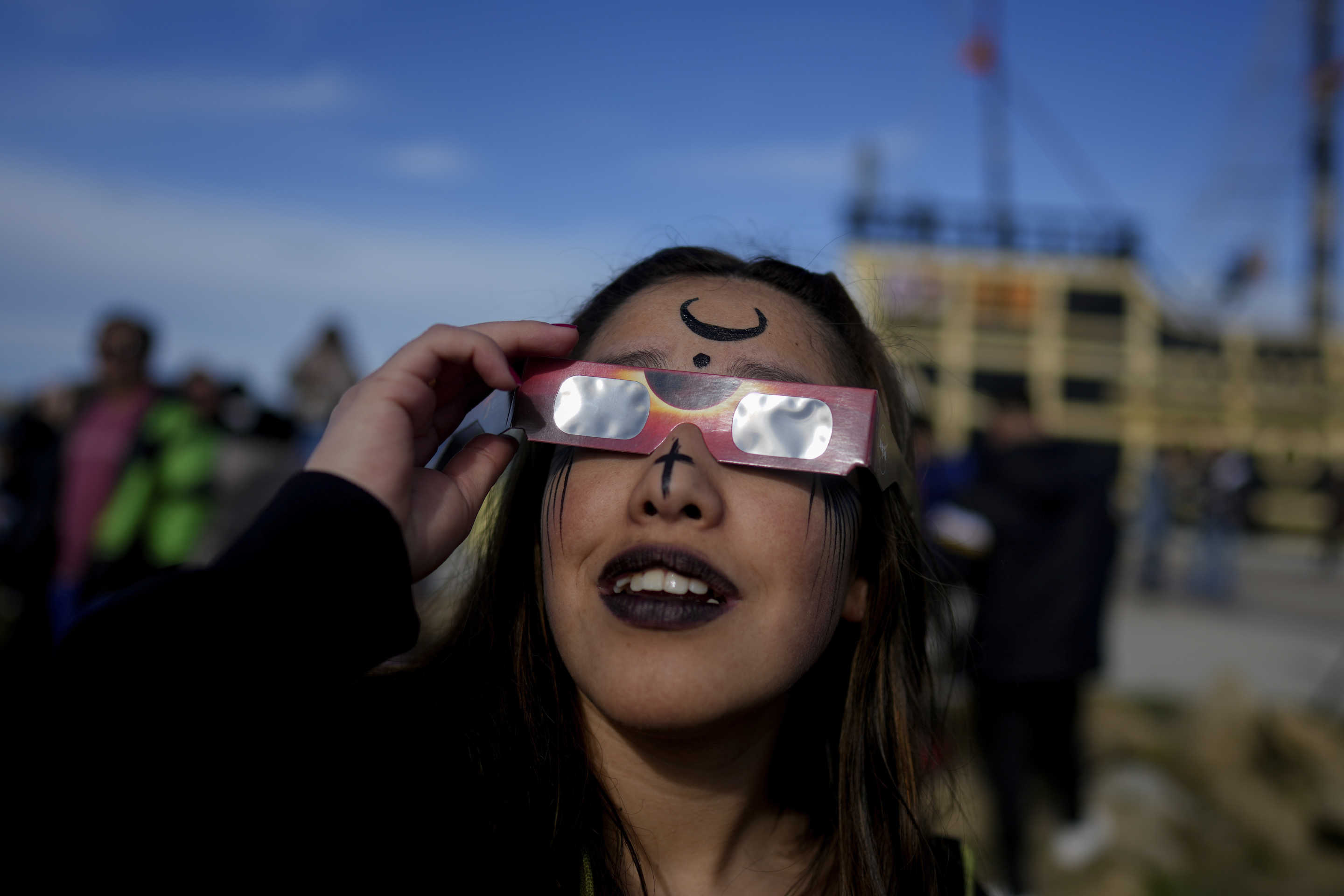 People watch an annular solar eclipse in Puerto San Julian, Argentina, on Wednesday.