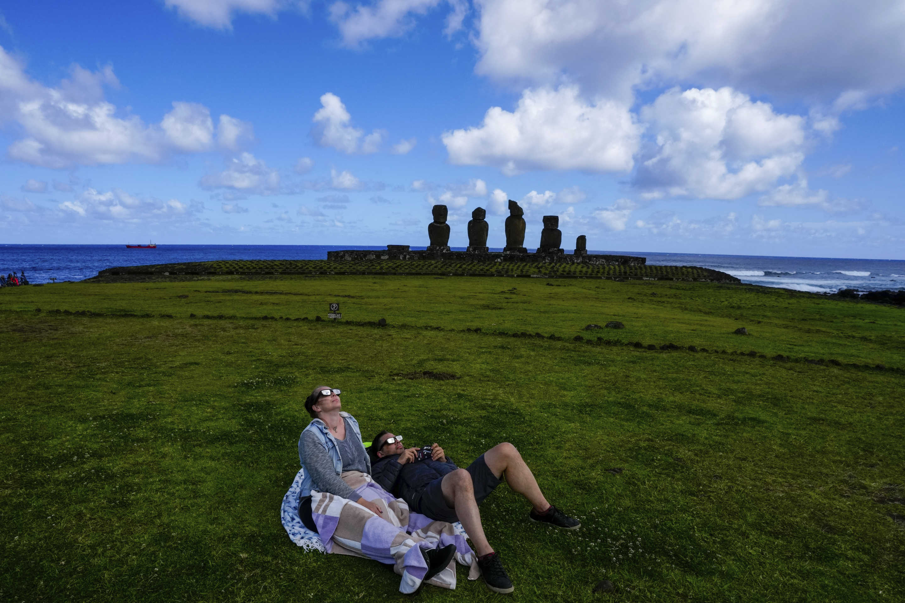 People watch the annular solar eclipse in Tahai, Rapa Nui, or Easter Island, Chile, on Wednesday.