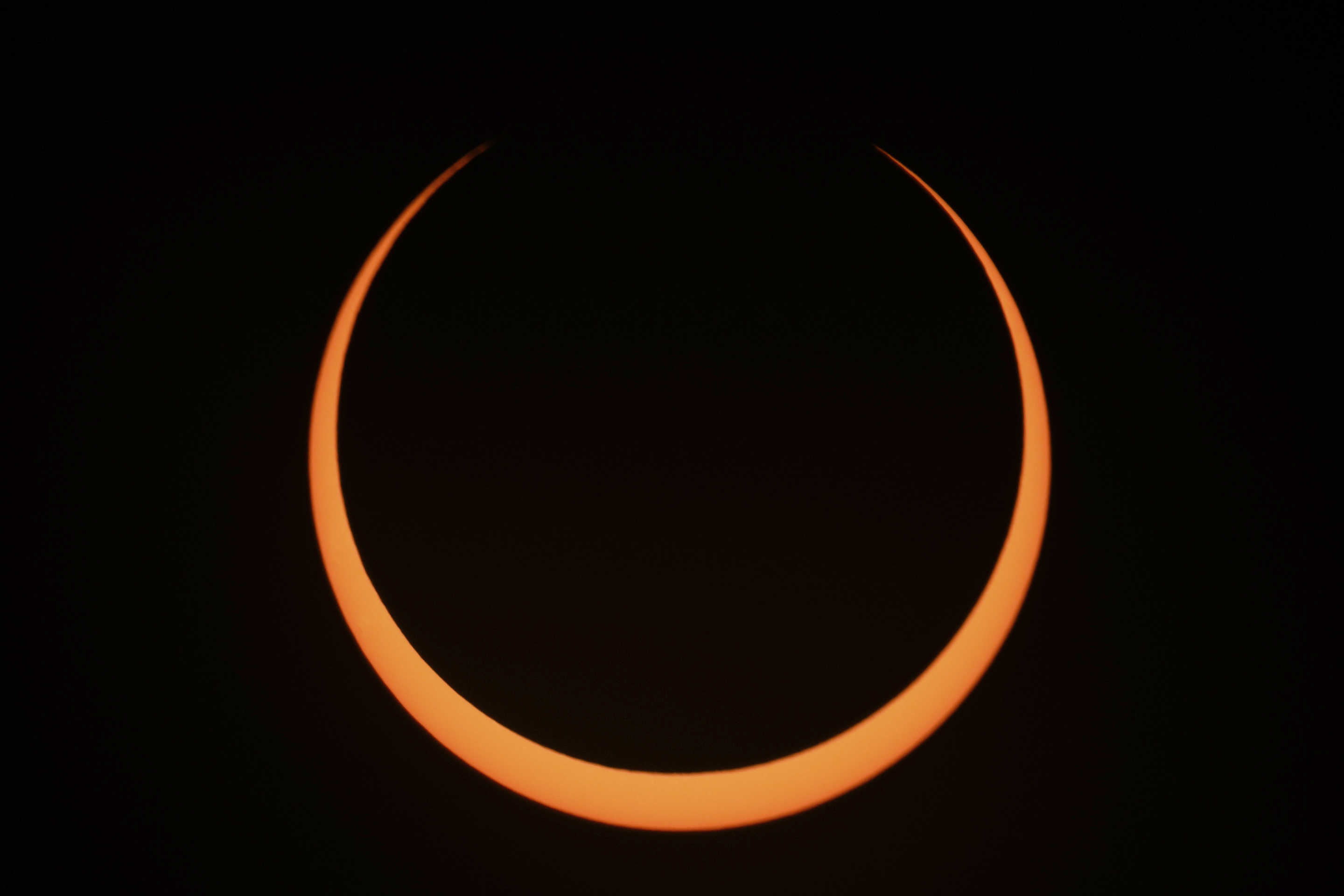 The moon moves across the sun during an annular solar eclipse seen from Tahai, Rapa Nui, or Easter Island, Chile, on Wednesday.