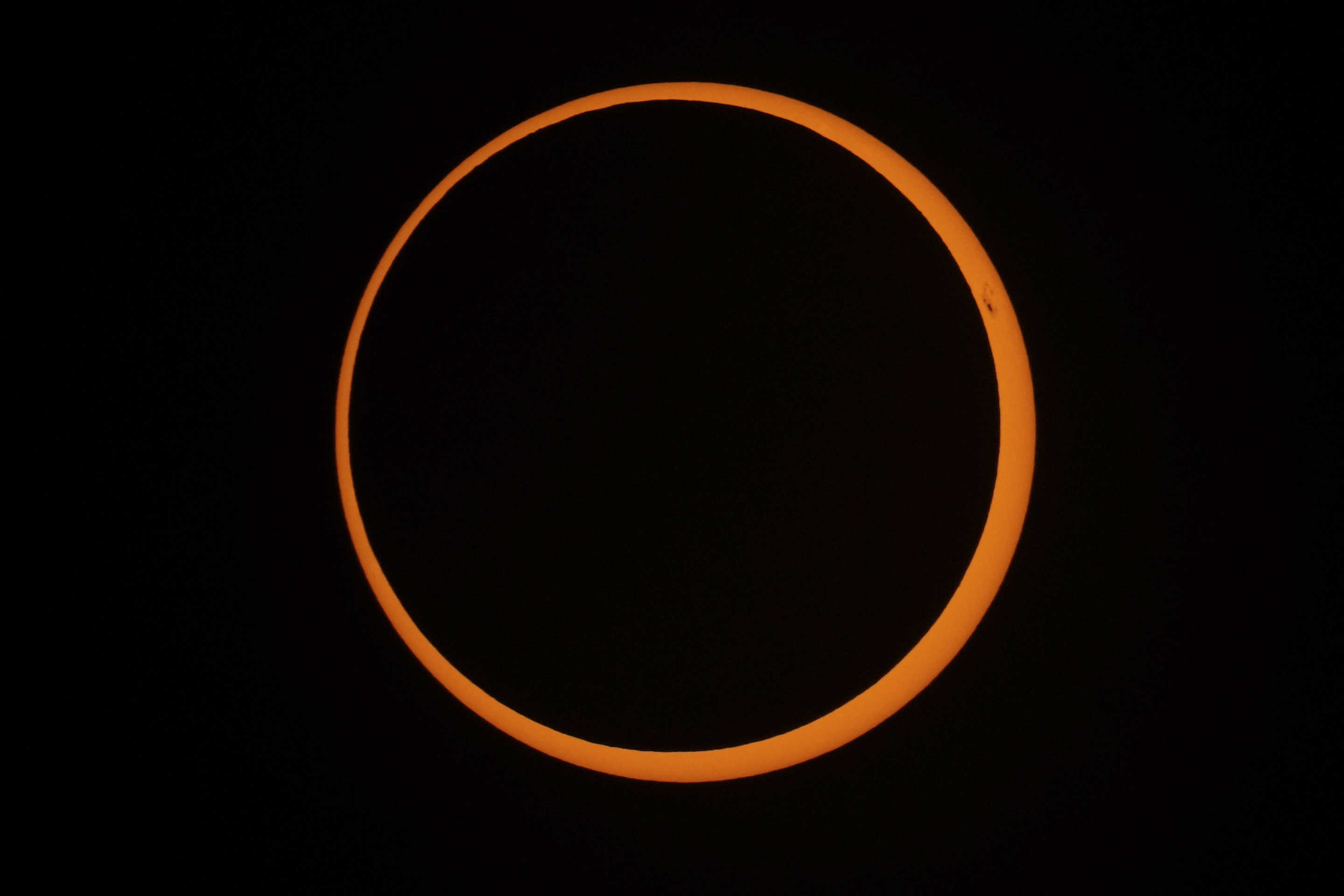 The moon moves across the sun during an annular solar eclipse in Tahai, Rapa Nui, or Easter Island, Chile, on Wednesday.