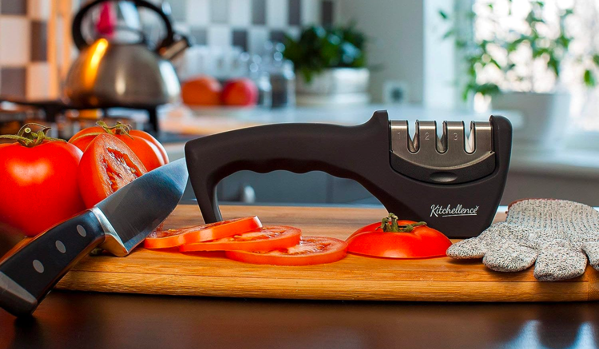 knife sharpener on a counter next to slices of tomato