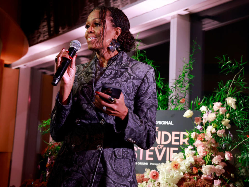 NEW YORK, NEW YORK - OCTOBER 02: Michelle Obama speaks on stage as Audible And Higher Ground Host “The Wonder Of Stevie" Event At CultureCon on October 02, 2024 in New York City. (Photo by Jason Mendez/Getty Images for Audible)