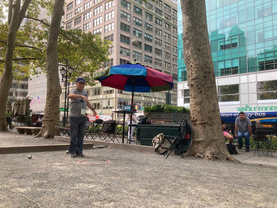 Francois Lelan, 92, shows how to play the French game pétanque in New York City's Bryant Park on Sept. 23, 2024.