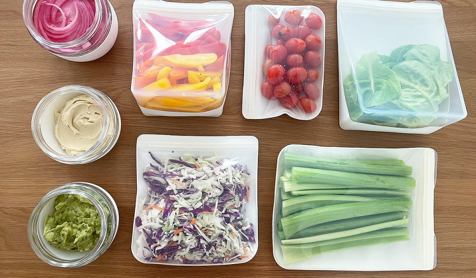 W&P's glass food storage jars shown filled with spreads (left), their reusable silicone bags filled with produce (right)