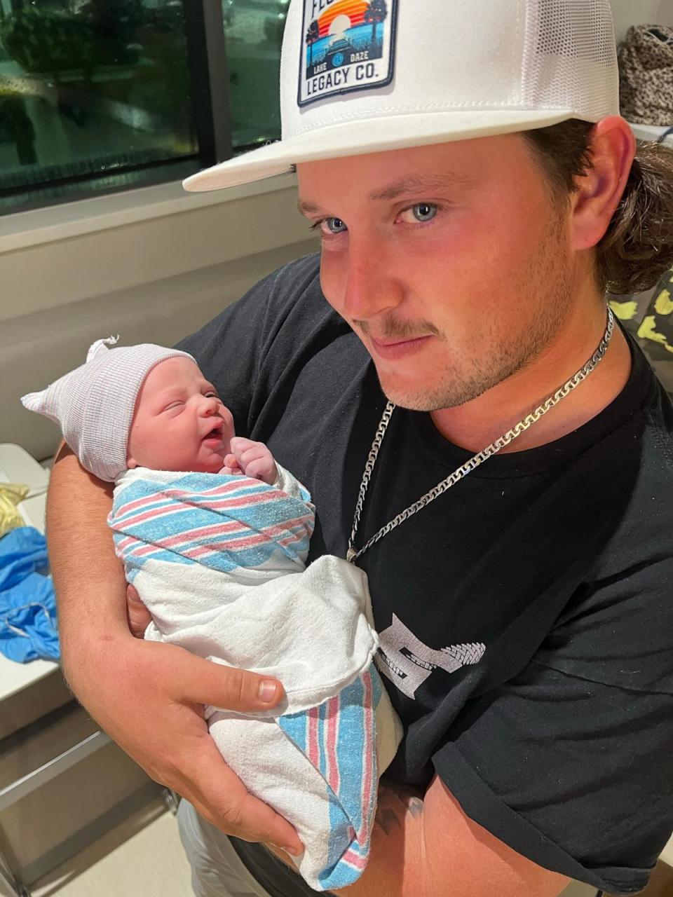 PHOTO: Dewey Bennett III holds his son and namesake Dewey Lester Bennett IV. (Sarasota Memorial Hospital)