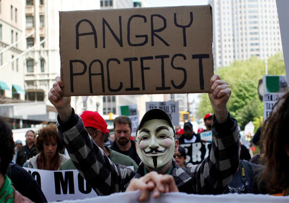 A demonstrator affiliated with "AIDS Coalition to Unleash Power" (Act Up) carries a sign during a joint protest between Act Up and the Occupy Wall Street movement in New York in April 2012. Act Up began in 1987 as part of a larger movement to prompt action from the federal government and medical establishment in the fight against HIV/AIDS.