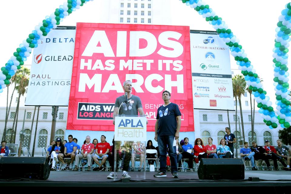 Craig E. Thompson (L), CEO of APLA Health, and AIDS Walk Los Angeles founder Craig Miller speak during AIDS Walk Los Angeles' event in October 2019. The world's first-ever AIDS walk marks its 40th annual event on October 13, 2024.