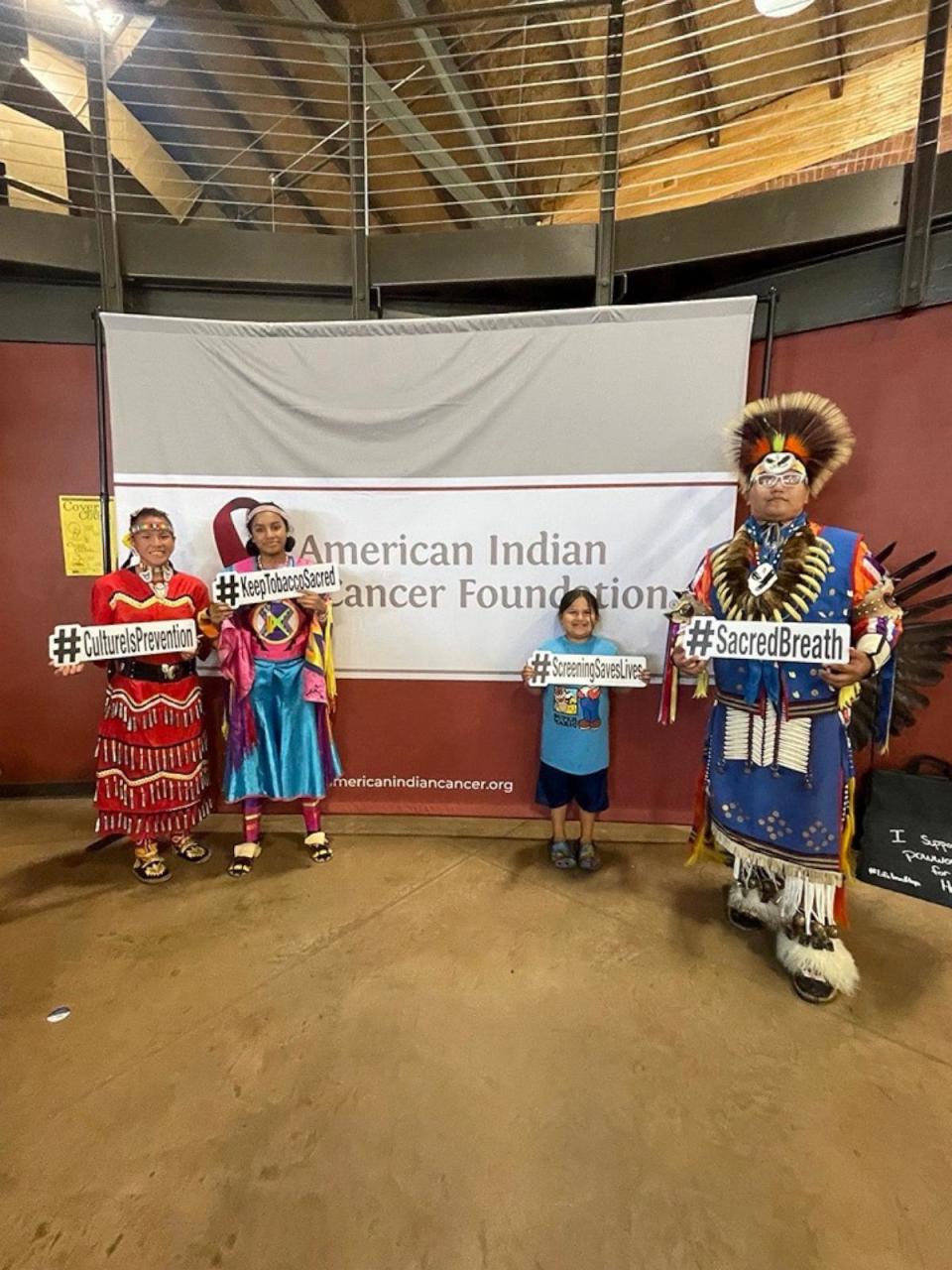 PHOTO: Participants hold signs at the 2024 Powwow for Hope in Minneapolis, hosted by the American Indian Cancer Foundation. ( American Indian Cancer Foundation)