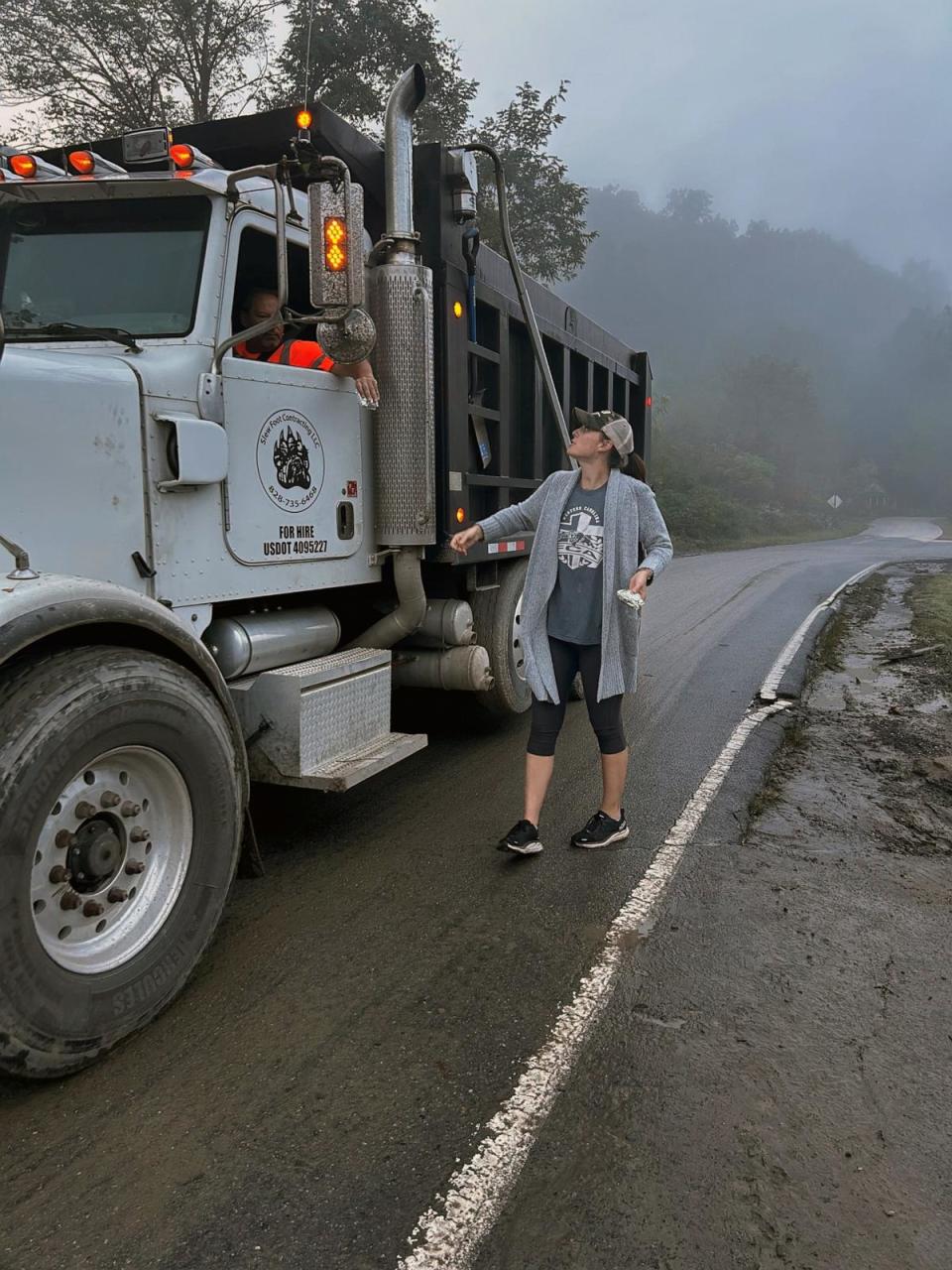 PHOTO: Heather Smith, North Carolina's 2024 teacher of the year, speaks with a repairman working in her hometown of Waynesville, N.C., after Hurricane Helene. (Courtesy Heather Smith)