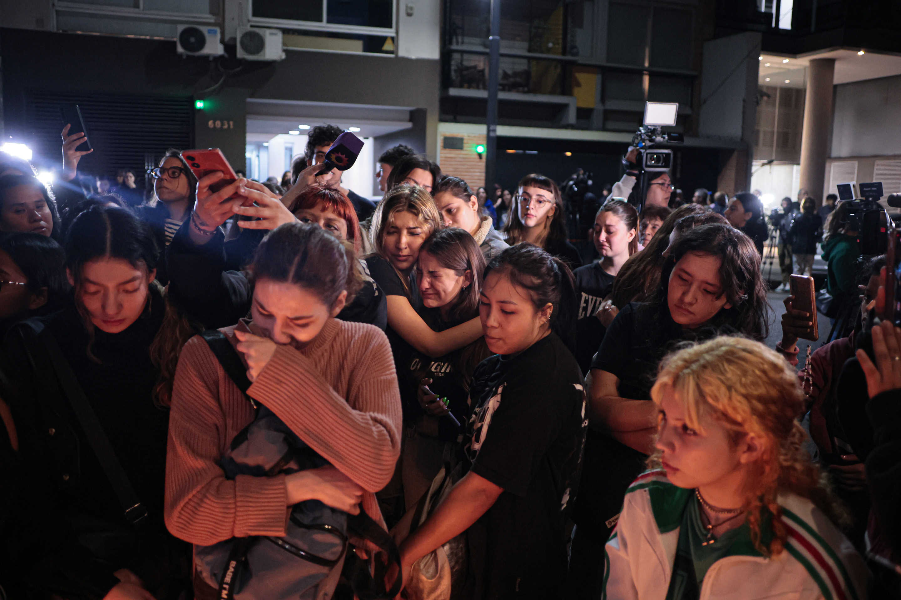 Fans of One Direction and Liam Payne gathered outside the hotel to sing the band's songs and leave a candle at an improvised altar on Wednesday.