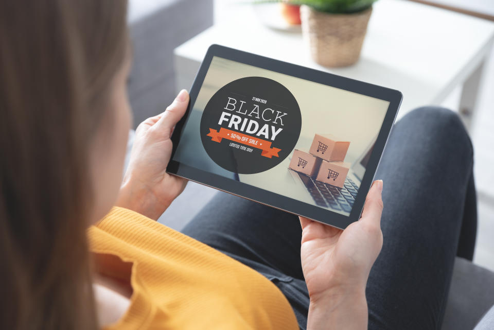 Woman looking at Black Friday imagery on an iPad