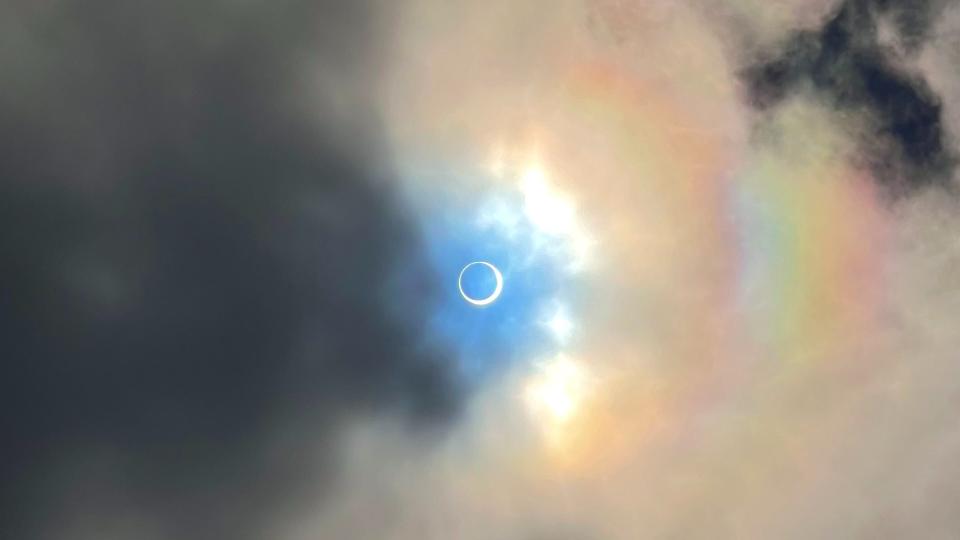 a dark black circle covers most of the sun, leaving just a bright orange ring around its edges