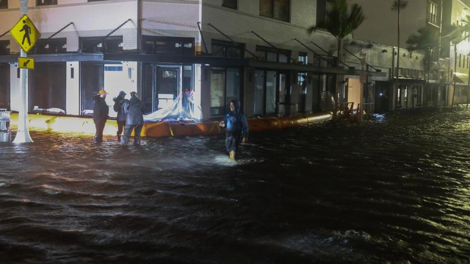 PHOTO: Members of the media work in flooded streets after Hurricane Milton made landfall in the Sarasota area on Oct. 9, 2024, in Fort Myers, Fla. (Joe Raedle/Getty Images)