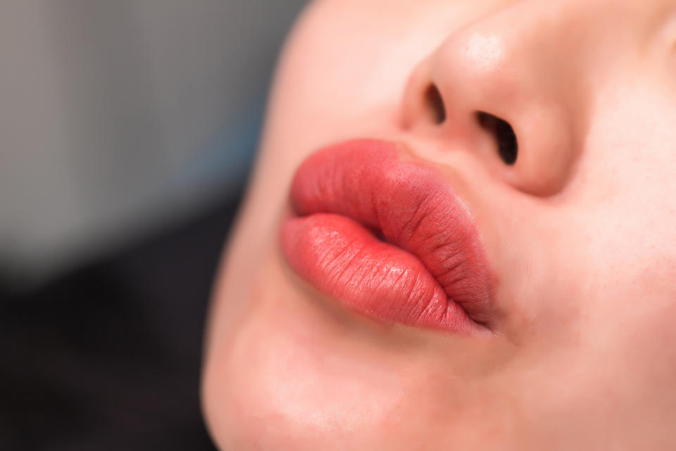 A woman making a kissy face. 