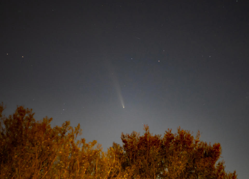 a bright white, fuzzy streak in the night sky