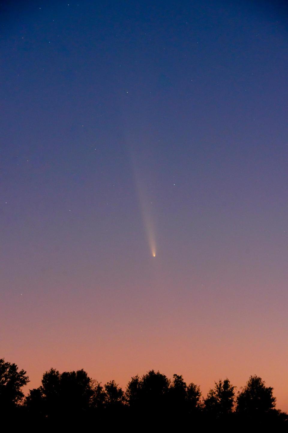 a bright white, fuzzy streak in the night sky